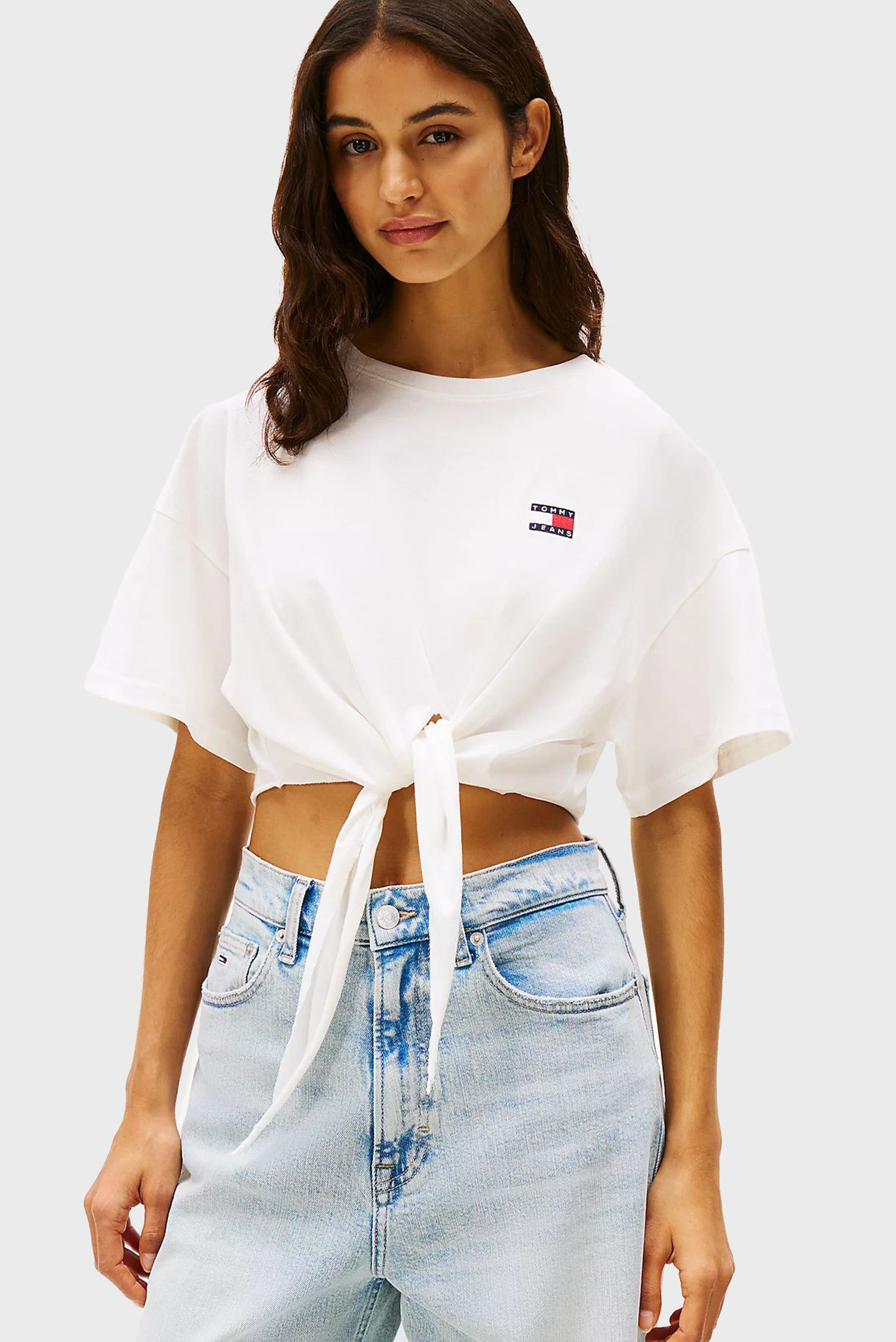 Женская белая футболка TJW REG WAIST TIE BADGE Белый S Tommy Jeans DW0DW20321 Женская белая футболка TJW REG WAIST TIE BADGE Белый S Tommy Jeans DW0DW20321